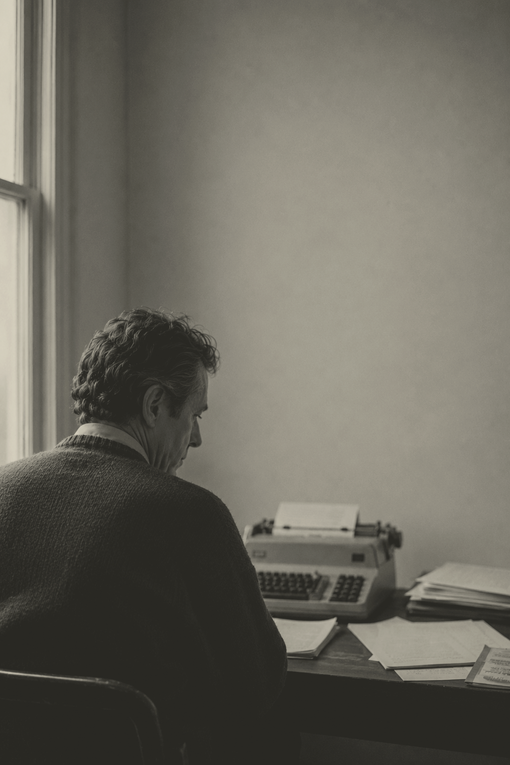 Arthur Sterling seated at a desk with papers